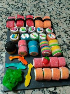 there are many different types of sushi on the counter top, including rolls and rainbows