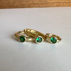 Elevate your earring stack with our exquisite gold huggies with the May birthstone - emerald! These stunning emerald hoops are featured in a solid 14k gold bezel setting. Designed for conch piercings, helix piercings, and most other cartilage piercings, these versatile huggie earrings add a touch of glamour and elegance to any ensemble, making them a perfect choice for those born in May or anyone looking to make a stylish statement in green.Item Details• Material: 14k Solid Yellow Gold• Gemstone Stackable 14k Gold Huggie Earrings, 14k Gold Stackable Round Huggie Earrings, Stackable Round Huggie Earrings For Anniversary, Stackable Huggie Earrings Fine Jewelry For Gift, 14k Gold Stackable Huggie Earrings As A Gift, Stackable Huggie Earrings As Gift In Fine Jewelry, Stackable 14k Gold Huggie Earrings For Anniversary, 14k Gold Huggie Earrings With Bezel Setting, Everyday Huggie Earrings With Bezel Setting