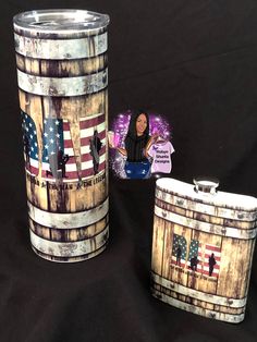 two wooden barrels with american flags painted on them and one has a sticker in the shape of an american flag