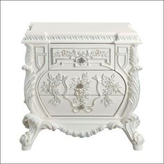 an ornate white cabinet with carvings on the doors and drawers is shown against a white background