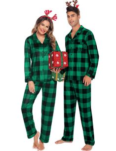 a man and woman in christmas pajamas standing next to each other