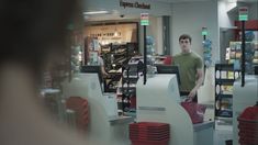 a man standing in front of a store filled with items