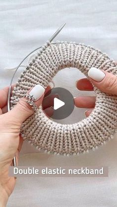 a woman is holding a knitted ring with scissors in her hand and the video below shows how to do it