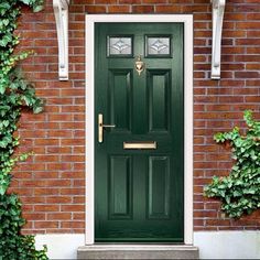 a green front door on a brick building