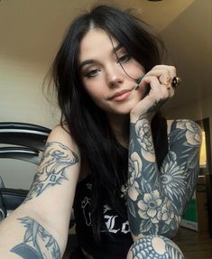 a woman with tattoos on her arms and arm