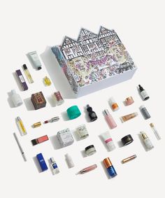 an assortment of cosmetics and beauty products laid out on a white surface