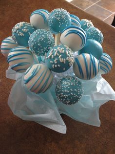 blue and white cake pops arranged in a vase