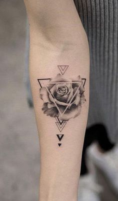 a woman's arm with a rose and triangles tattoo on the left side of her leg