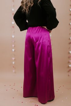 Unveil elegance with our "Best For Last" Satin Pants in Magenta. These luxurious pants exude sophistication with their smooth satin finish and vibrant magenta hue. Perfect for making a bold fashion statement at special events or elevating your everyday style. Date Night outfit inspo Waistband: High rise Fabric: 95% Polyester, 5% Spandex Sleek satin fabrication Adjustable tie belt waistband Wide leg bottom Imported Fit: True to size!- Waist: Elastic/High rise- Leg: Wide leg - Stretch only in wais Elegant Pink Satin Bottoms, Chic Bottoms With Satin Finish For Party, Chic Satin Finish Bottoms For Party, Chic Party Bottoms With Satin Finish, Glamorous Satin Pants For Formal Occasions, Glamorous Satin Bottoms For Evening, Glamorous Satin Formal Pants, Purple Bottoms For Evening In Spring, Purple Bottoms For Spring Evening