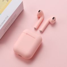 an apple airpods sitting on top of a pink surface next to a box with the packaging