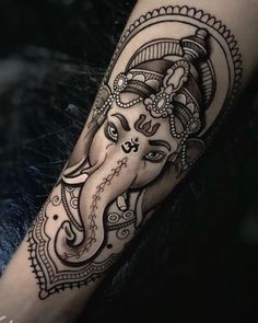 an elephant tattoo on the arm with intricate designs and details in it's head