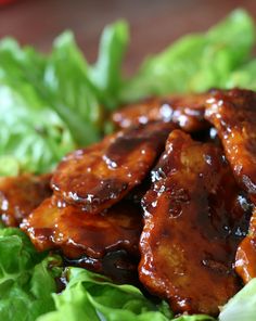 chicken wings with sauce on top of lettuce