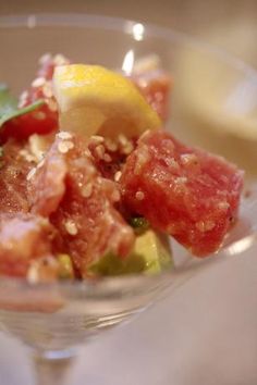 a close up of a small glass bowl filled with fruit and vegtables