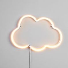 a cloud shaped neon sign on a white wall