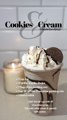 an ice cream sundae with cookies and cream in it on a table next to a lit candle