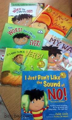 five children's books sitting on top of a wooden table