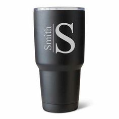 a black tumbler cup with the letter s on it