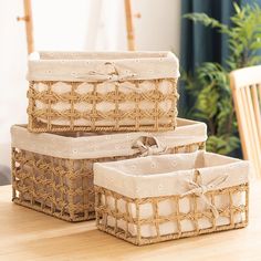 three wicker baskets sitting on top of a wooden table