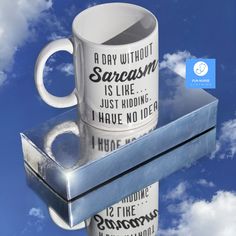 two coffee mugs sitting on top of each other in front of blue sky with clouds