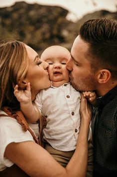 a man and woman kissing their baby boy