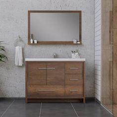 a bathroom with a sink, mirror and potted plant on the floor in front of it