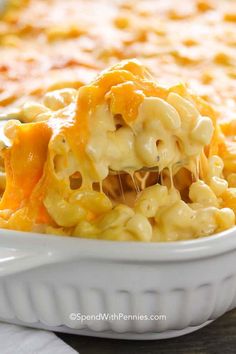 macaroni and cheese being lifted from a casserole dish