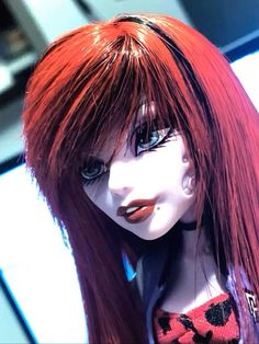 a red haired doll with long hair and piercings