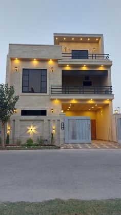 the front of a house with lights on it