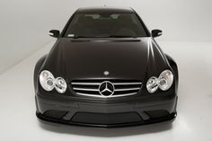 the front end of a black mercedes benz coupe