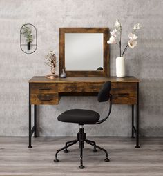 a desk with a mirror, chair and vase on it in front of a wall