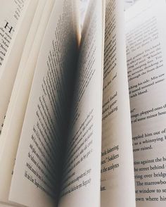 an open book sitting on top of a table next to another book with the pages folded down