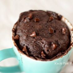 a chocolate cake in a blue cup on a table