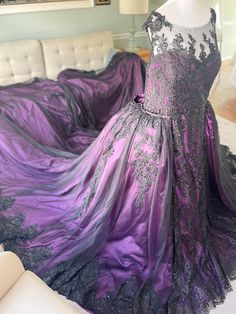 a purple and black dress on display in a living room