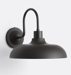 a black wall light on a white wall