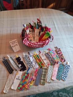 a table topped with lots of different items on top of a cloth covered tablecloth