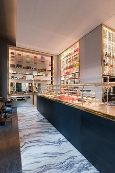 a restaurant with marble flooring and shelves filled with food