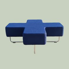 two blue chairs sitting next to each other on top of a green surface with metal legs