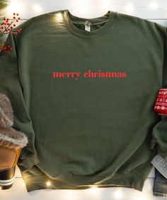 This unisex sweatshirt is for Christmas lovers. Available as a Unisex Sweatshirt or as a Unisex Hoodie. Primary photo = Sweatshirt "Military Green" ♥PRODUCTION TIME: 1-5 days (usually 2-3 days) ♥SHIPPING TIME: 2-5 days (usually 3 days) ♥PRODUCT DESCRIPTION: The Gildan 18000/18500 is ideal for any situation, a unisex heavy blend crewneck sweatshirt/hoodie is pure comfort. These garments are made from polyester and cotton. This combination helps designs come out looking fresh and beautiful. The co Casual Christmas Crew Sweatshirt, Casual Christmas Crew Neck Sweatshirt, Casual Christmas Sweatshirt With Letter Print, Holiday Crew Neck Sweater With Letter Print, Christmas Sweatshirt With Letter Print, Christmas Sweatshirt With Letter Print And Relaxed Fit, Christmas Sweatshirt With Letter Print In Relaxed Fit, Red Christmas Sweatshirt With Letter Print, Christmas Crew Neck Sweater With Letter Print