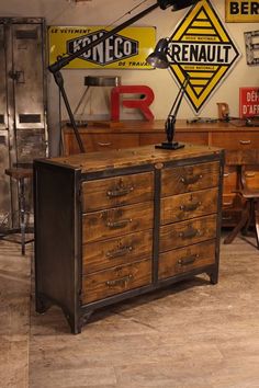 an industrial style dresser in a room with signs on the wall