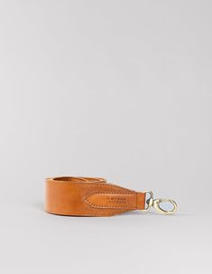 The details on this strap are made from our classic leather, which has a classy, yet modern and sophisticated look. It is characterized by its shining surface and a smooth and gentle feel. Our premium quality sustainable leather is tanned without the use of harmful chemicals and has no synthetic top finish. This natural leather has an open structure, which means that scratching will occur and irregularity in color and texture are a part of this leather. These characteristics make it a unique pro Classic Leather Bag Strap For Travel, Formal Brown Bridle Leather Belts And Suspenders, Brown Leather Shoulder Strap, Classic Leather Adjustable Bag Strap, Classic Adjustable Bag Strap, Luxury Leather Shoulder Strap For Everyday, Luxury Brown Bag Strap For Everyday, Brown Leather Shoulder Strap For Everyday Use, Everyday Brown Leather Shoulder Strap