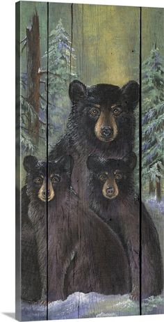 three bears are standing in front of a wood panel with trees and snow on it