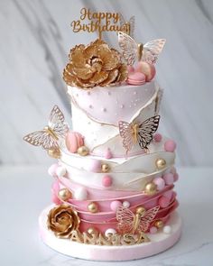 a three tiered cake decorated with butterflies and flowers