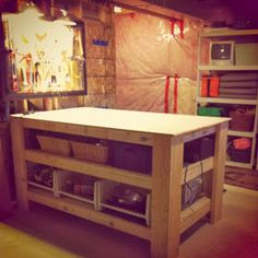 a kitchen island made out of plywood with baskets on the bottom and shelves below