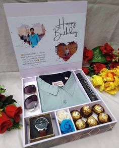 a birthday gift box with an assortment of men's clothing and chocolates in it