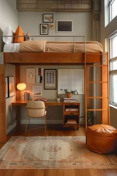 a loft bed with a desk underneath it and pictures on the wall behind it in a bedroom