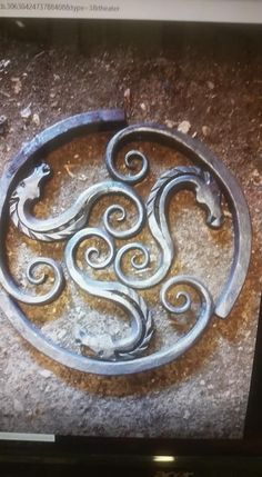 a metal object sitting on top of a cement floor