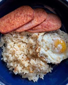 sausage, rice and eggs on a blue plate