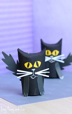 two black cats made out of toilet paper