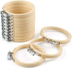 a stack of wooden rings with screws and nuts in them on a white background