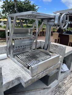 a grill sitting on top of a wooden table